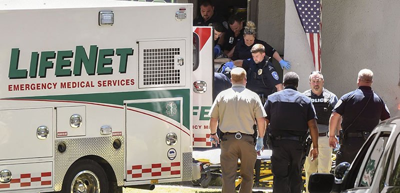 The Sentinel-Record/Grace Brown MURDER SCENE: First responders carry an injured man, who later died, on a gurney from 2216 Malvern Ave. after police were called to the area in reference to a shooting around 1:30 p.m. Wednesday.