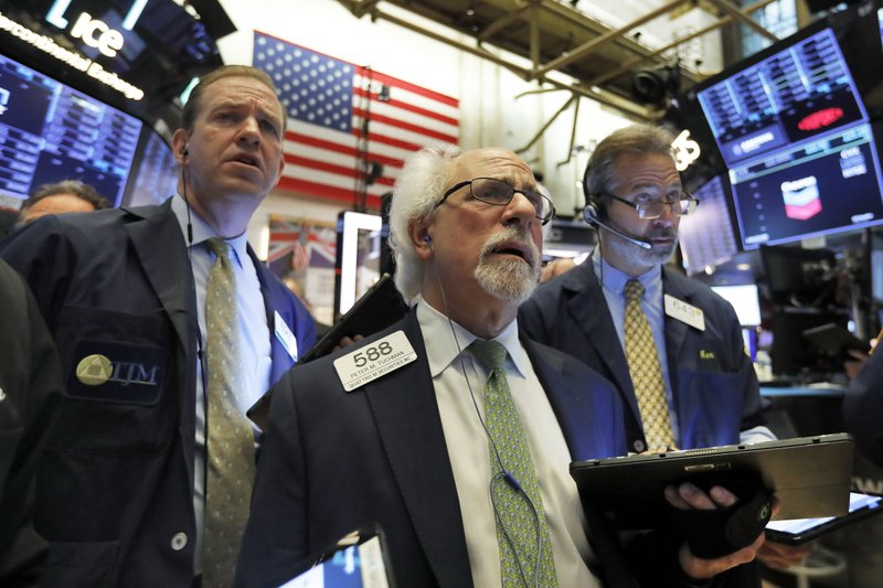 Peter Tuchman, center, works with fellow traders on the floor of the New York Stock Exchange, Wednesday, June 19, 2019. Investors are in wait-and-see mode hours ahead of a widely anticipated Federal Reserve decision on interest rates. (AP Photo/Richard Drew)