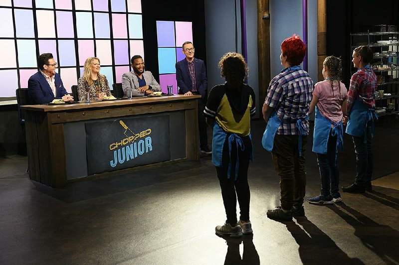 Host Ted Allen (center) with judges Anthony Anderson, Amanda Freitag, and Scott Conant during appetizer round tasting and judging on Chopped Junior.
