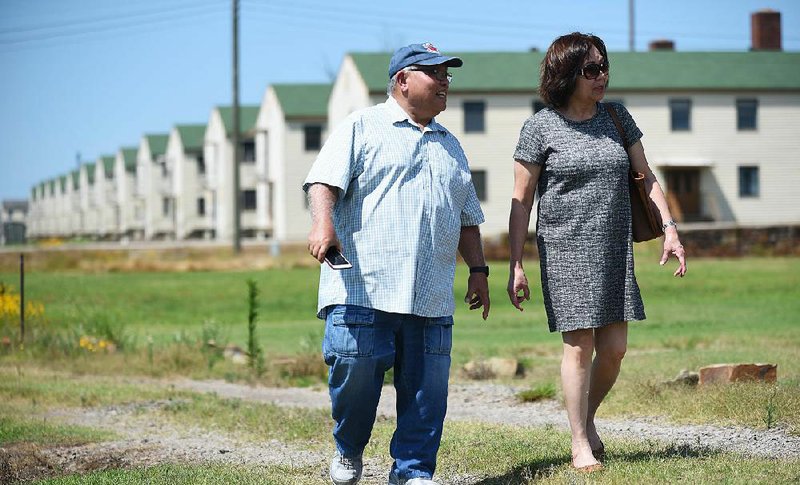 Nghi and Phuong Le walk past former housing quarters Wednesday at Fort Chaffee, where they first lived after fleeing Vietnam in 1975. More photos are available at arkansasonline.com/620chaffee/ 