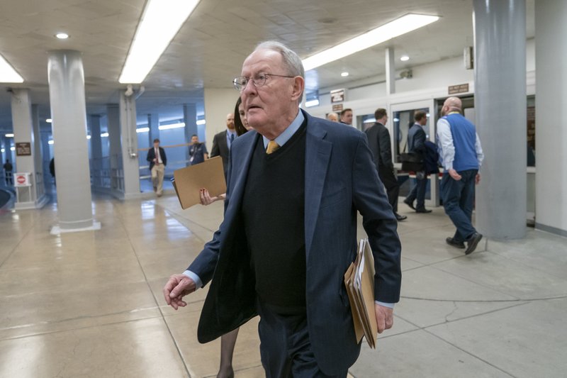 FILE - In this Feb. 12, 2019, file photo, Sen. Lamar Alexander, R-Tenn., walks to the Senate at the Capitol in Washington. A new study says about once in every six times someone is taken to an emergency room or checks in to a hospital as an in-patient, the treatment is followed by a &#x201c;surprise&#x201d; medical bill. (AP Photo/J. Scott Applewhite, File)