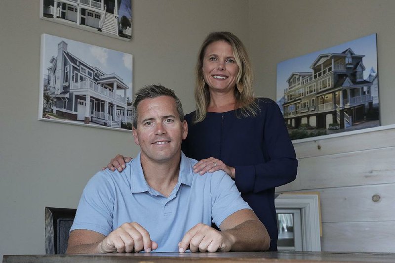 Chris Carr, president of McLaughlin Construction Management, poses for a photo with his wife, Kristy Carr, in their office in Sea Isle City, N.J. Before he died, Chris Carr’s father-in-law made no plans for keeping his home-building business open, so Carr, an accountant, took over. 