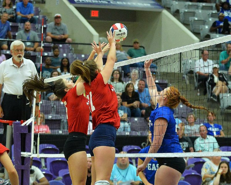 The West’s Joni Inman (left) of Paris fires a volley during the Arkansas High School Coaches Association All-Star volleyball match Friday in the Farris Center in Conway. The East won 9-25, 25-16, 25-21, 25-12, 15-10. More photos from this game are available at arkansasonline.com/galleries. 