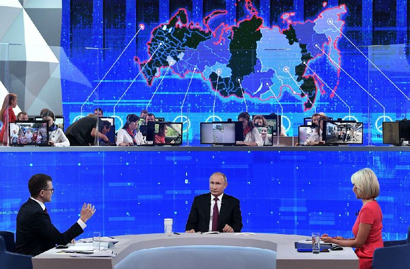 Russian President Vladimir Putin takes calls Thursday on national television. The annual “Direct Line” call-in show has been a core element of Putin’s image-making since 2001. 