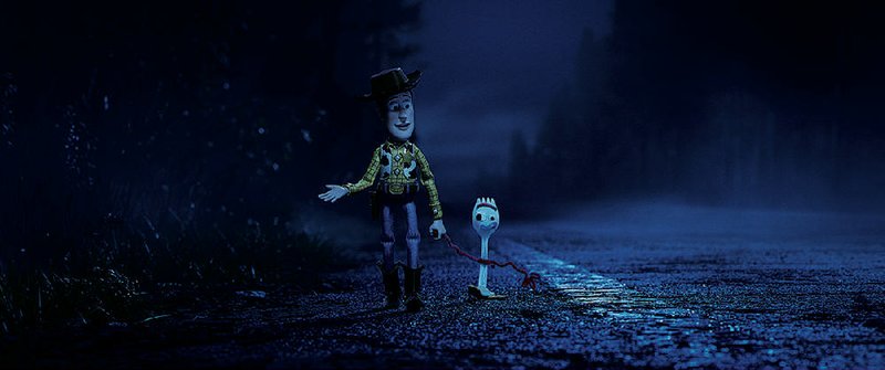 Sheriff Woody (voice of Tom Hanks, right) coaches Forky (Tony Hale), a craft project made from a discarded utensil, on the finer points of being a loyal toy in Toy Story 4. 