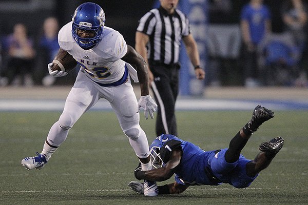 North Little Rock running back Brandon Thomas (22) shakes off Conway defensive back Tez Miller (1) during the first quarter of North Little Rock's 35-14 win on Friday, Sept. 28, 2018, in Conway.
