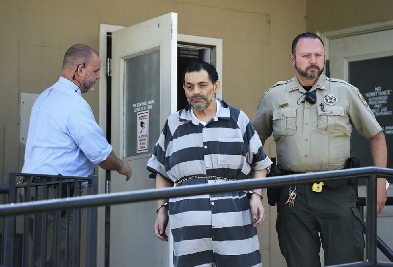FILE — Mauricio Alejandro Torres is escorted out of the Benton County Courthouse Annex on June 22 in Bentonville. He is facing a second trial in the death of his 6-year-old son.