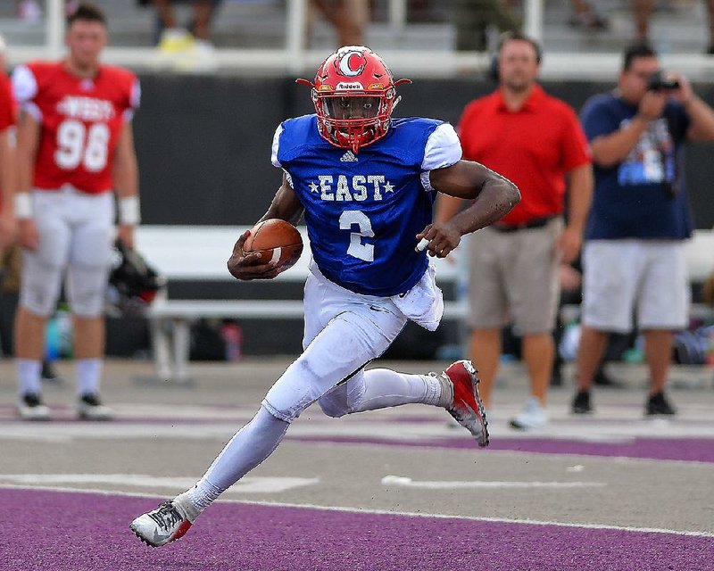 East quarterback Demilon Brown of Rivercrest runs for a first down during the 64th annual Arkansas High School Coaches Association football game at Estes Stadium in Conway. Brown, who completed 10 of 13 passes for 136 yards and rushed for 105 yards on 11 carries, was named MVP. More photos from Saturday’s All-Star games are available at arkansasonline.com/galleries.  