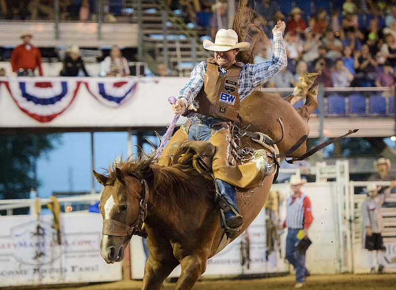 File Photo/CHARLIE KAIJO Curtis Garton of Lake Charles, La., competes in the saddle bronc event during the 74th annual Rodeo of the Ozarks.