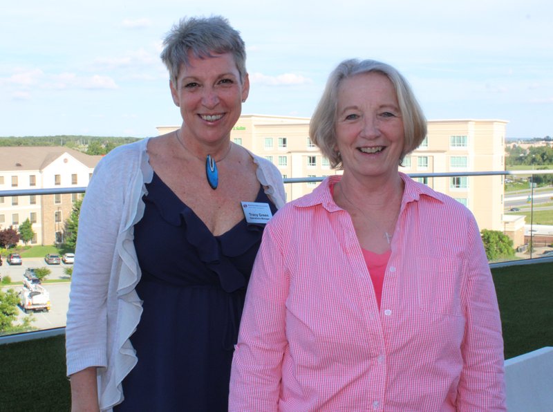 NWA Democrat-Gazette/CARIN SCHOPPMEYER Tracy Green (left) and Elaine Smith visit at the Dress for Success reception.