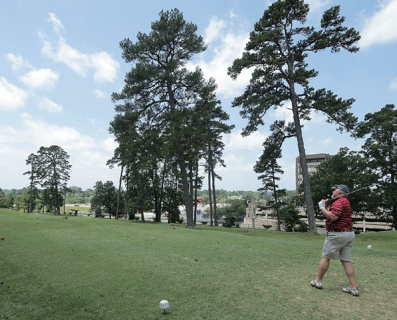 Golfer Shawn Todd of Jacksonville tees off at Little Rock’s War Memorial public golf course. The city plans to close the course early next month. 