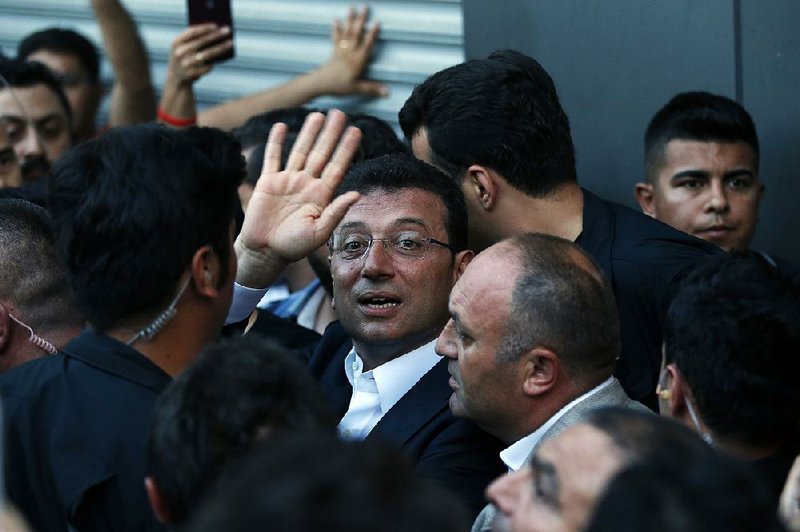 Istanbul’s newly elected mayor, Ekrem Imamoglu, waves to his supporters in the city Sunday outside the Republican People’s Party offices. 