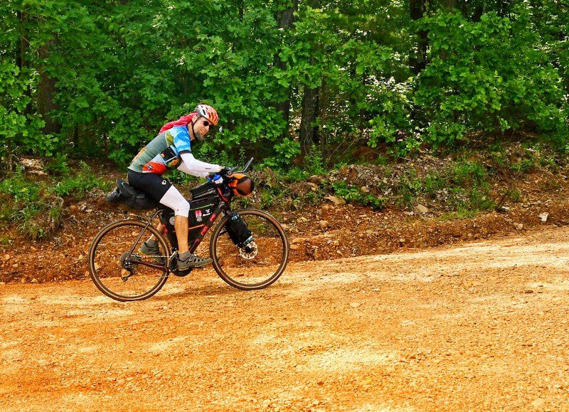 Chuck Campbell pedals uphill on gravel near Wildcat Mountain in the Winona Wildlife Management Area during the first Arkansas High Country Race, June 8. (Special to the Democrat-Gazette/MICHAEL ROYS)