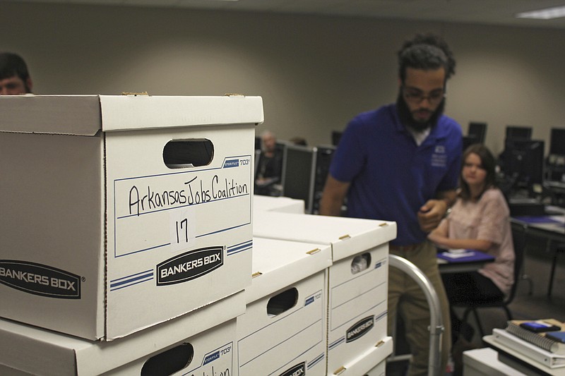 FILE - This July 6, 2018, file photo shows boxes containing petitions in favor of a proposal to legalize casinos in Arkansas, delivered to the Arkansas secretary of state's office in Little Rock, Ark. Voters in several states dominated politically by Republicans have passed ballot initiatives in recent years to expand Medicaid, legalize marijuana, raise the minimum wage and reform the redistricting process. This has led several GOP legislatures and governors to begin cracking down on the initiative process in ways that will make it harder for the public to quality ballot measures. (AP Photo/Andrew Demillo, File)