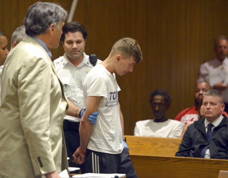 Volodymyr Zhukovskyy, 23, of West Springfield, is escorted into the courtroom for his arraignment in Springfield District Court, Monday, June 24, 2019, in Springfield, Mass. Zhukovskyy, the driver of a truck in a fiery collision on a rural New Hampshire highway that killed seven motorcyclists, was charged Monday with seven counts of negligent homicide. (Don Treeger/The Republican via AP, Pool)