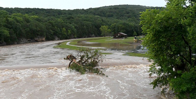 The White River floods Riverside Park in West Fork Sunday June 23, 2019.