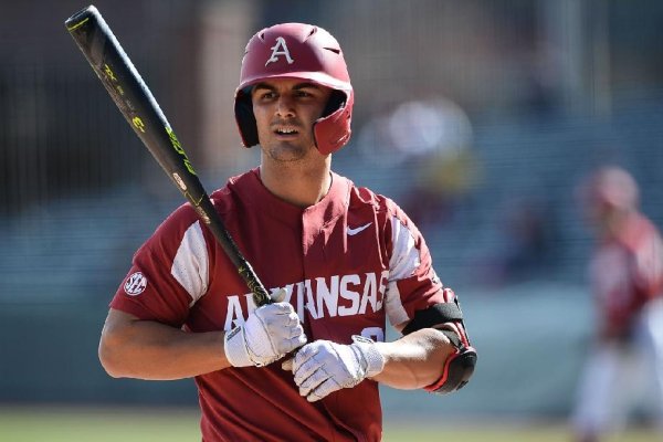 Arkansas designated hitter Jordan McFarland checks the dugout for the sign before an at-bat against Western Illinois Wednesday, March 13, 2019, during the third inning at Baum-Walker Stadium in Fayetteville. Visit nwadg.com/photos to see more photos from the game.