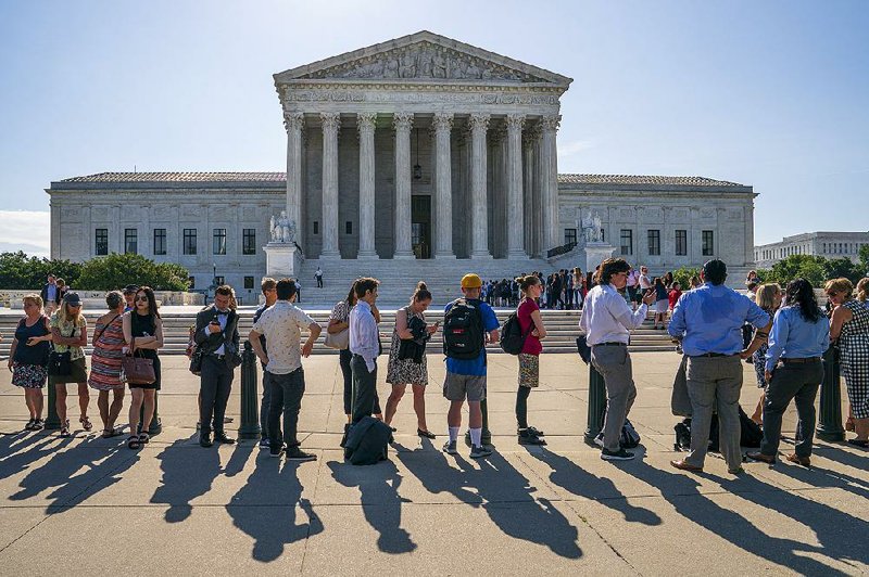 People line up Monday outside the Supreme Court building in Washington. 