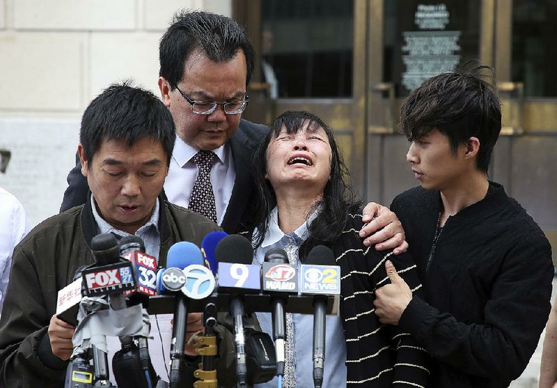 Lifeng Ye, the mother of slain University of Illinois visiting scholar Yingying Zhang, cries out in grief Monday as her husband Ronggao Zhang (left) addresses reporters after a federal jury convicted Brendt Christensen of murder in Peoria, Ill. 