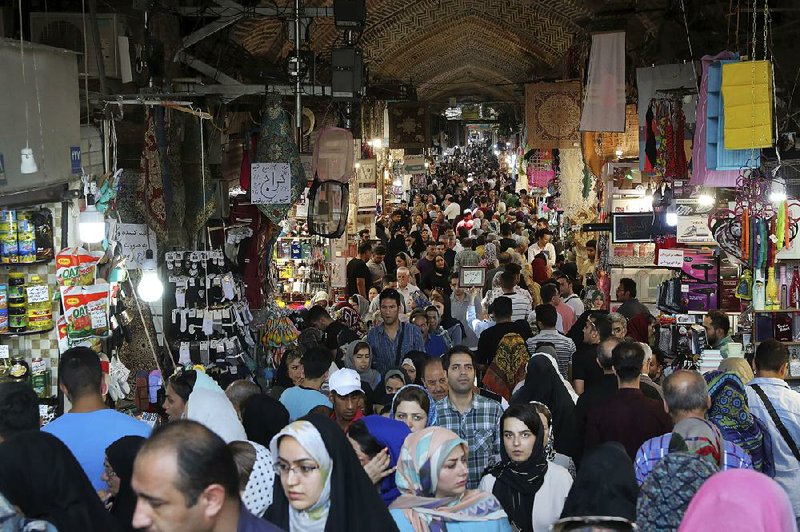 People shop at the old main bazaar in Tehran, Iran, on Sunday. 