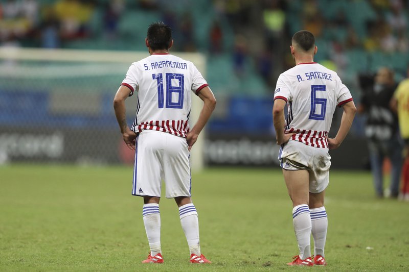 Paraguay's Santiago Arzamendia, left, and Richard Sanchez stands on the pitch at the end of a Copa America Group B soccer match at the Arena Fonte Nova in Salvador, Brazil, Sunday, June 23, 2019. (AP Photo/Natacha Pisarenko)