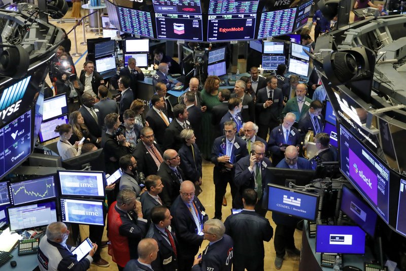 FILE - In this June 20, 2019, file photo traders gather at a post on the floor of the New York Stock Exchange as they wait for the Slack Technologies IPO to begin trading. Stocks are off to a mixed start on Wall Street on Monday, June 24, as gains for technology companies are offset by losses in health care and other sectors. (AP Photo/Richard Drew, File)