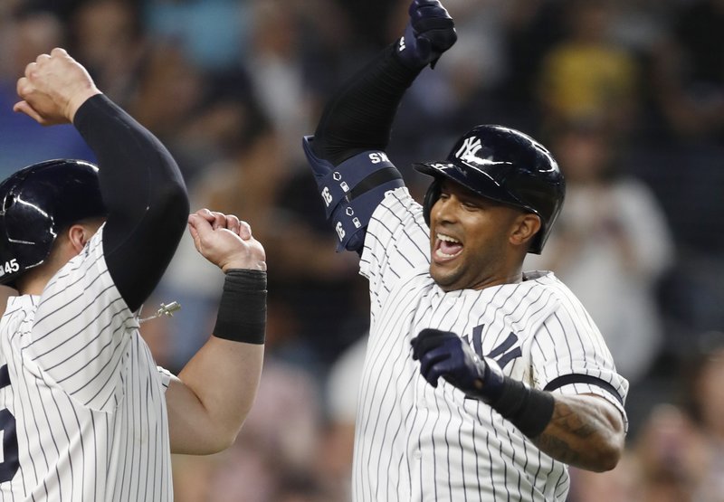 New York Yankees' Aaron Hicks, right, celebrates with designated hitter Luke Voit, after they scored on Hicks' three-run home run during the fifth inning of a baseball game against the Toronto Blue Jays, Monday, June 24, 2019, in New York. (AP Photo/Kathy Willens)