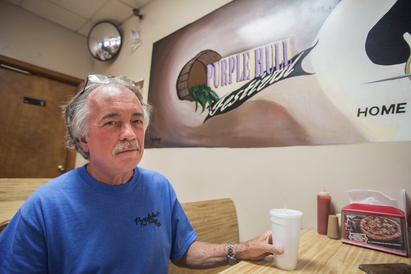 Bill Dailey, also known as the “Pea-R Guy,” who since 1992 has overseen the Emerson PurpleHull Pea Festival and World Championship Tiller Race public relations, sits at a booth in Emerson Food Mart after reminiscing about his years volunteering for his hometown event.