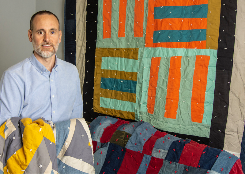 James Matthews stands in front of one of his quilts in his Stifft Station home. An exhibition of Matthews’ quilts — “Eviction Quilts by James Matthews” — has opened at the Arts & Science Center for Southeast Arkansas in Pine Bluff. (Arkansas Democrat-Gazette/CARY JENKINS)
