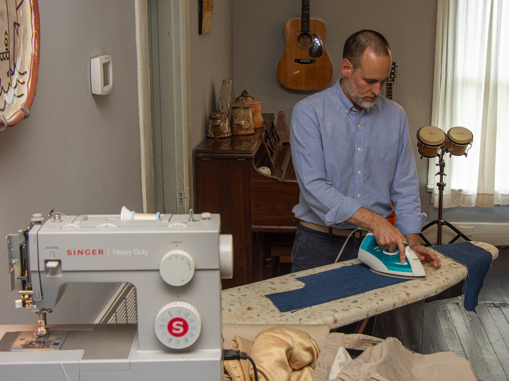 James Matthews irons cloth for use in his quilts. (Arkansas Democrat-Gazette/CARY JENKINS)