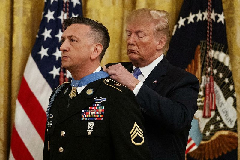 Army Staff Sgt. David Bellavia receives the Medal of Honor on Tuesday from President Donald Trump at the White House. 