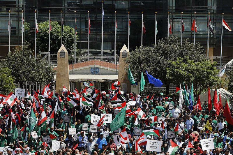Palestinians rally Tuesday in front of the United Nations headquarters in Beirut. The group was protesting a U.S.-sponsored economic aid plan that is the focus of a two-day workshop in Bahrain. 