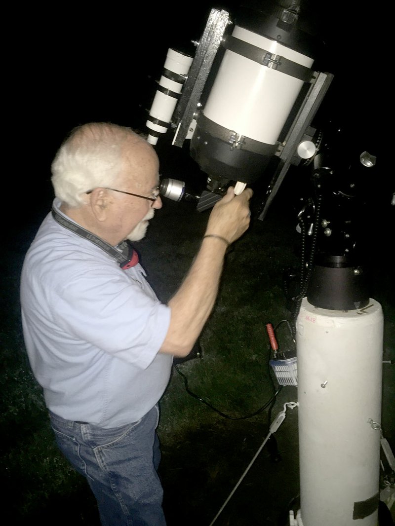 Graham Thomas/Herald-Leader Dr. David Cater calibrates his telescope for a night of star gazing during a recent evening in June.