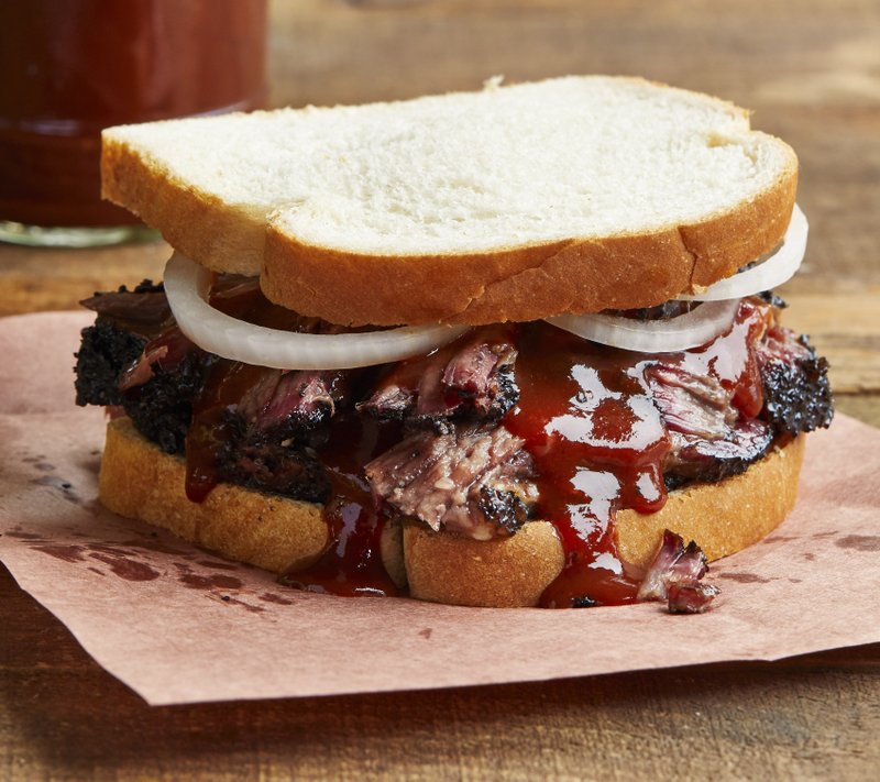 Barbecued brisket served Texas-style, with onions and sauce on white bread. Photo by Tara Donne (The New York Times)