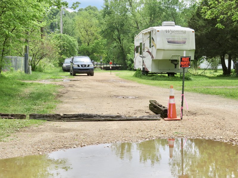 Westside Eagle Observer/RANDY MOLL According to boundary lines staked out by owners in this May 3 photo, the town street has shifted to the east (left) and onto the property of town residents.