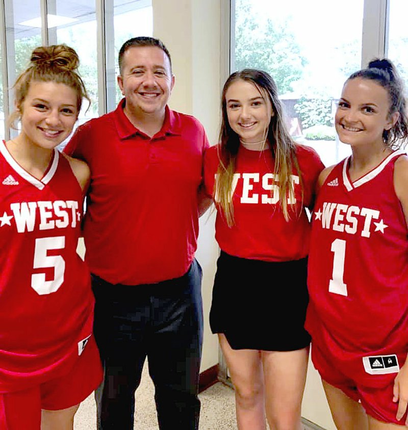 Submitted photo/Red is a familiar color for Farmington representatives on the 2019 Arkansas High School Coaches Association West All-Star girls basketball team (from left): Alexis Roach, West player; Brad Johnson, West head coach; Trinity Johnson, West manager; and Madisyn Pense, West player. The East defeated the West, 85-72, at the Jeff Farris Center on the UCA campus at Conway.