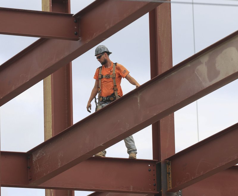 FILE — A worker makes his way across a steel beam as work continues on the new office building at 600 Main Street in North little Rock in this April 23 file photo.