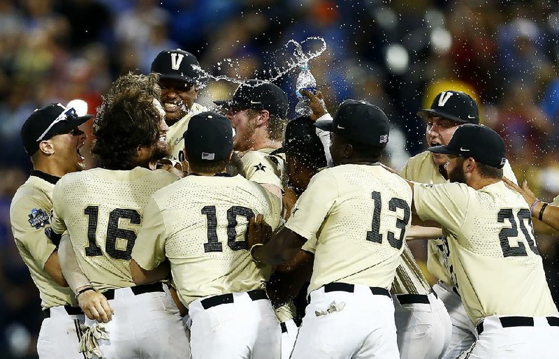 Vanderbilt players celebrate after defeating Michigan to win the national championship Wednesday night at the College World Series at TD Ameritrade Park in Omaha, Neb. It was the Commodores’ second national title. 