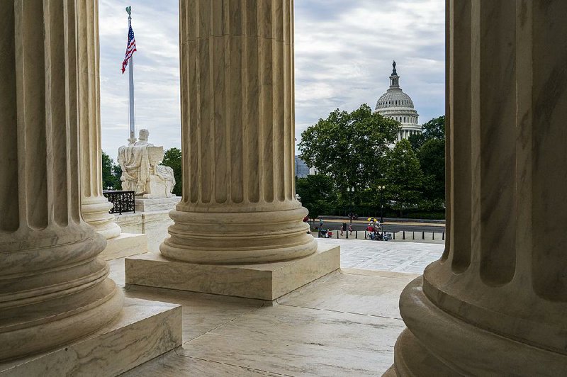 The U.S. Capitol is framed by the columns of the Supreme Court in Washington this week as the justices prepare today to issue the final decisions of the high court’s term. 
