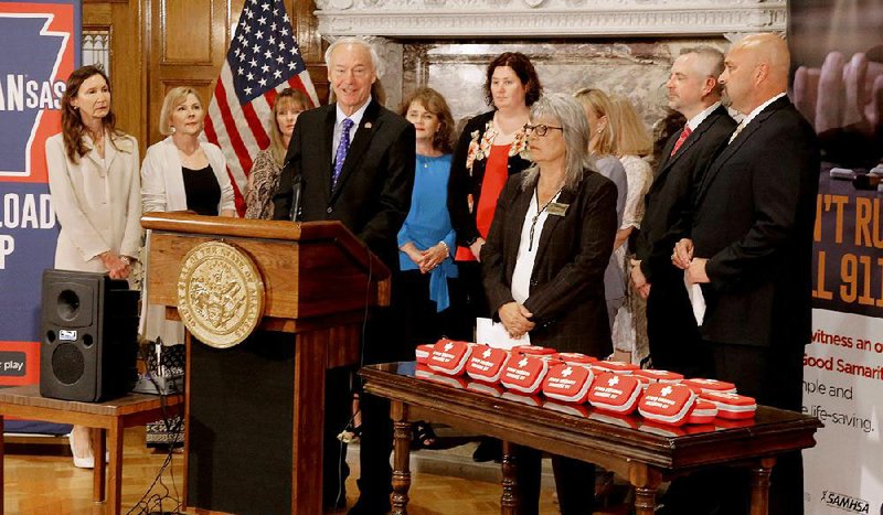 With naloxone kits on the table beside him, Gov. Asa Hutchinson says Tuesday at a Capitol news conference that in the opioid crisis, “the priority has to be in saving lives first.” More photos are available at arkansasonline.com/626narcankits/ 