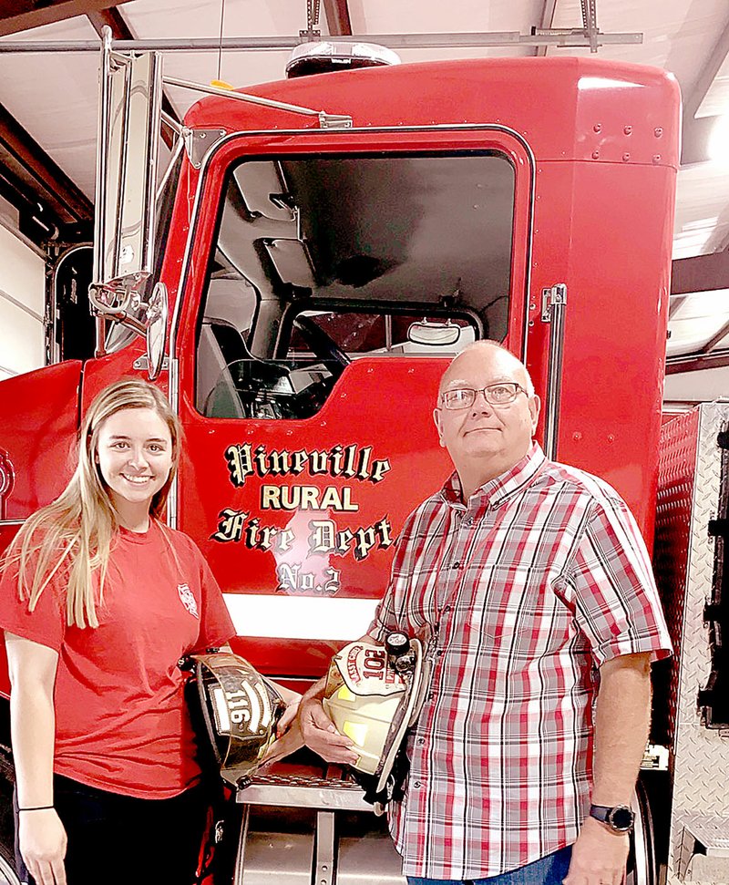 COURTESY PHOTO Pineville mayor and volunteer firefighter Gregg Sweeten (right) is pictured with his daughter Kalee. He recently won an essay contest in which he wrote about Kalee joining the volunteer fire department.