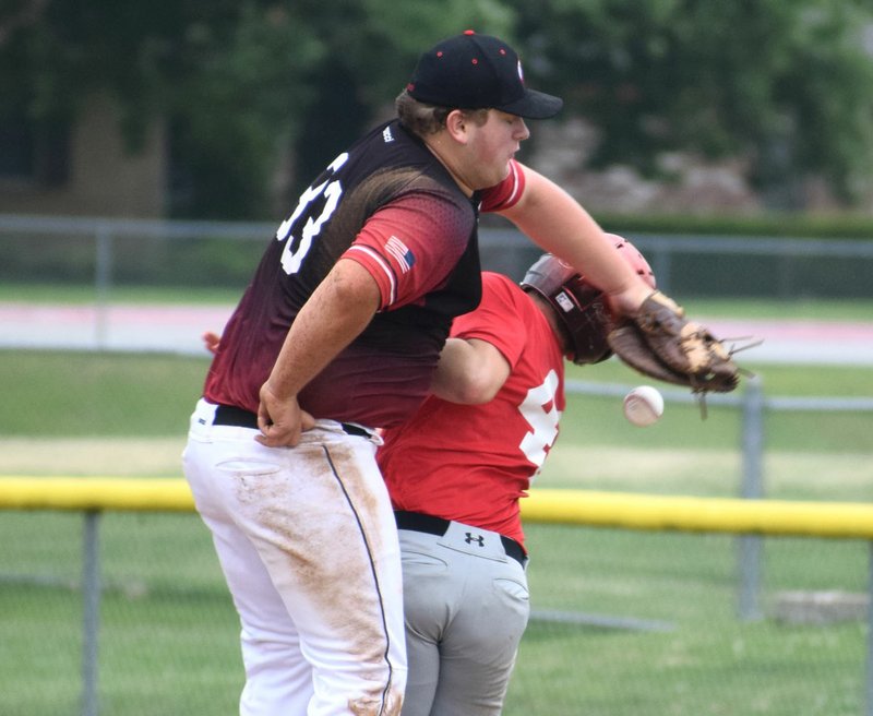 RICK PECK/SPECIAL TO MCDONALD COUNTY PRESS McDonald County's Weston Gordon collides with the first baseman from the Naturals Baseball Academy during McDonald County's 7-2 loss in the Jack Link's Mid-South Exposure on June 22 in Springdale, Ark.