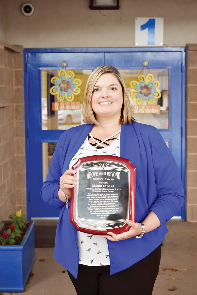 Mandi Dunlap, principal of Eastside Elementary School in the Greenbrier School District, holds her Above and Beyond award from the Arkansas Association of Elementary School Principals in conjunction with the national association. The award was named in honor of Dawn Hochsprung, the principal at Sandy Hook Elementary School, who was killed in 2012 during a school shooting in Newtown, Connecticut.