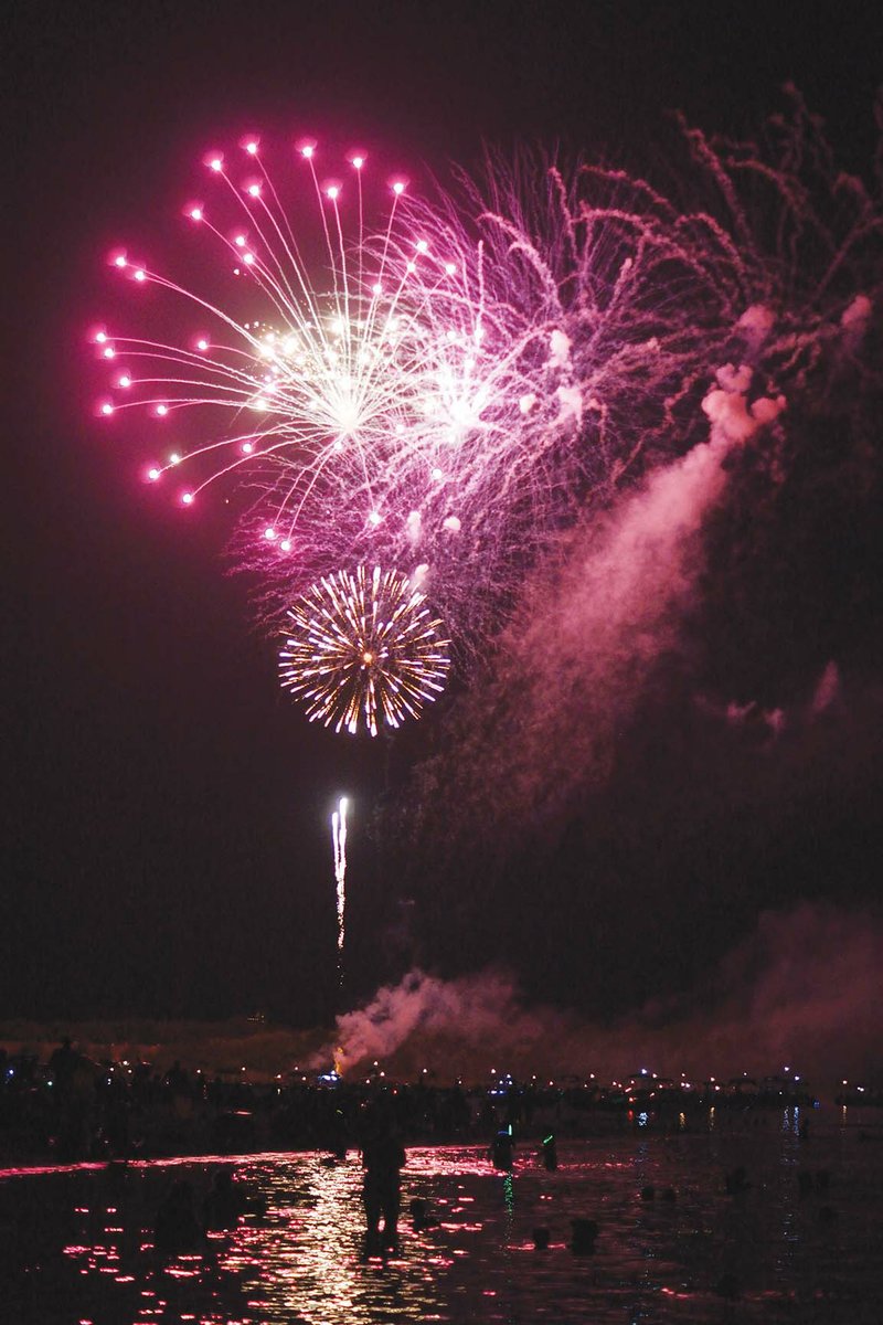 Spectators watch the Fireworks Extravaganza from the shore and water last year at Sandy Beach in Heber Springs. This year, the festivities and fireworks show, set for Saturday, have been moved to Dam Site Park, 315 Heber Springs Road N., because of high water.