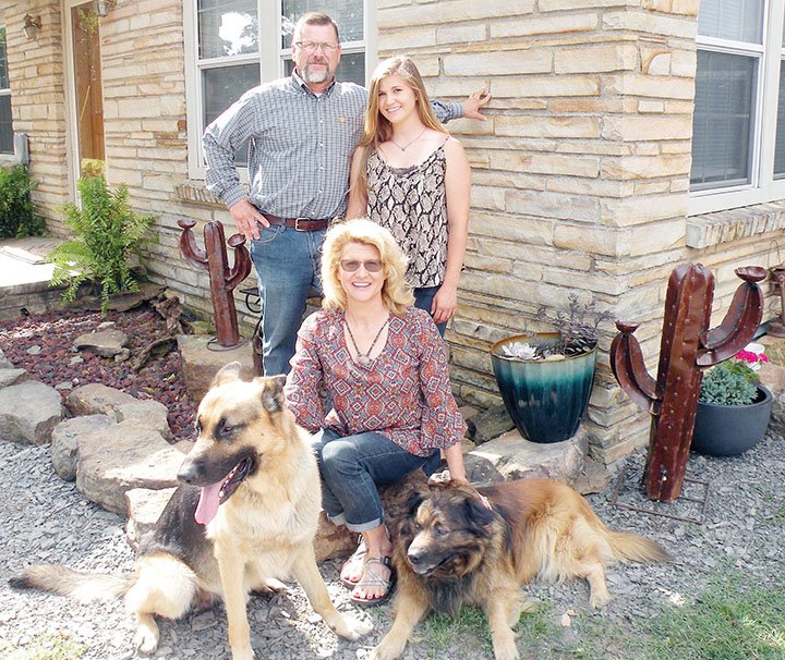 The Harrington family of Casa is the 2019 Perry County Farm Family of the Year. The family includes Flora Harrington, seated; her husband, Steve Harrington; and their 20-year-old daughter, Morgan. They raise poultry, cattle, horses and timber and have several dogs, including Spur, left, and Taz.