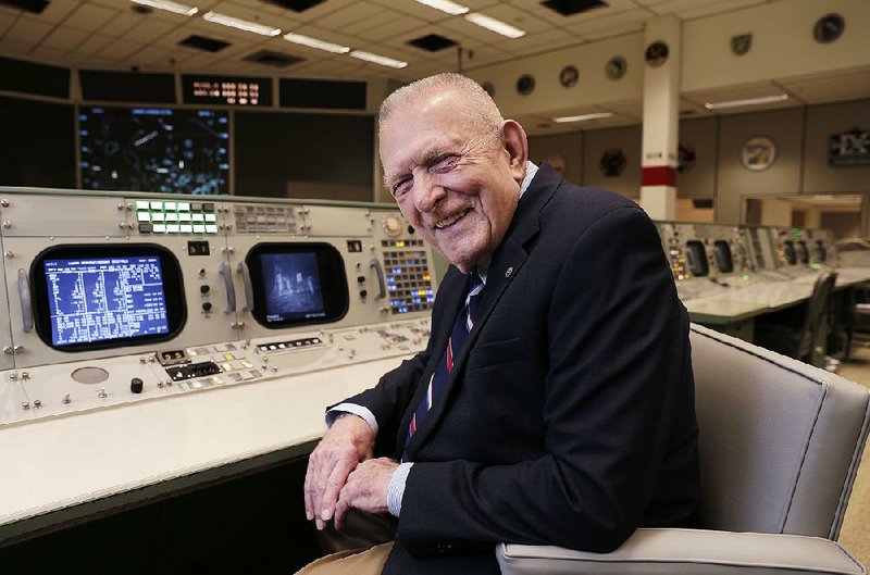 Gene Kranz sits at the console where he served as flight director for the Apollo 11 moon landing and many other missions during a visit June 17 to NASA’s Johnson Space Center in Houston. 