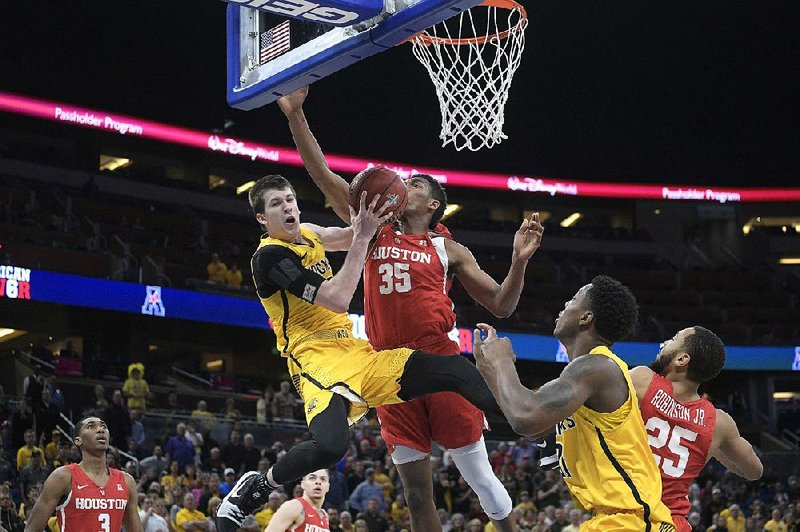 In this Saturday, March 10, 2018, file photo, Wichita State guard Austin Reaves (12) is fouled by Houston forward Fabian White Jr. (35) while going up for a shot during the second half of an NCAA college basketball game in the semifinals at the American Athletic Conference tournament in Orlando, Fla. Reaves is preparing for a big role with Oklahoma after transferring from Wichita State and sitting out last season. 
