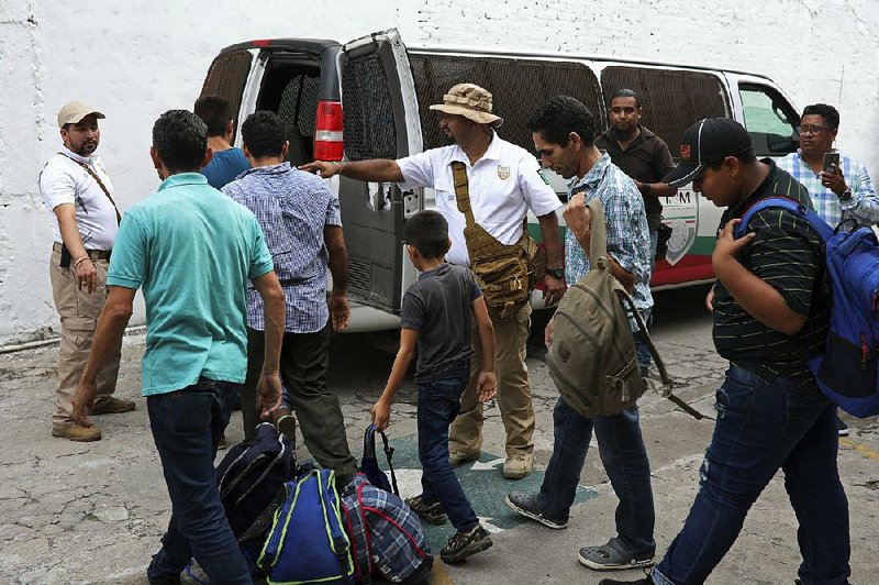 Mexican immigration agents round up Central Americans during a raid this week at a hotel in Veracruz. 