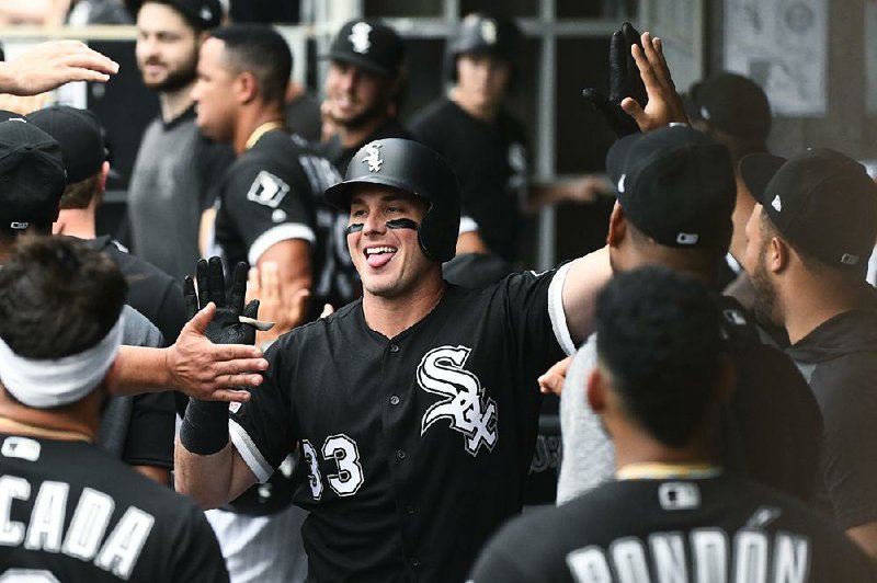 Chicago White Sox's James McCann (33) celebrates in the dugout after he hit a two-run home run during the first inning of a baseball game against the Minnesota Twins on Friday, June 28, 2019, in Chicago. 