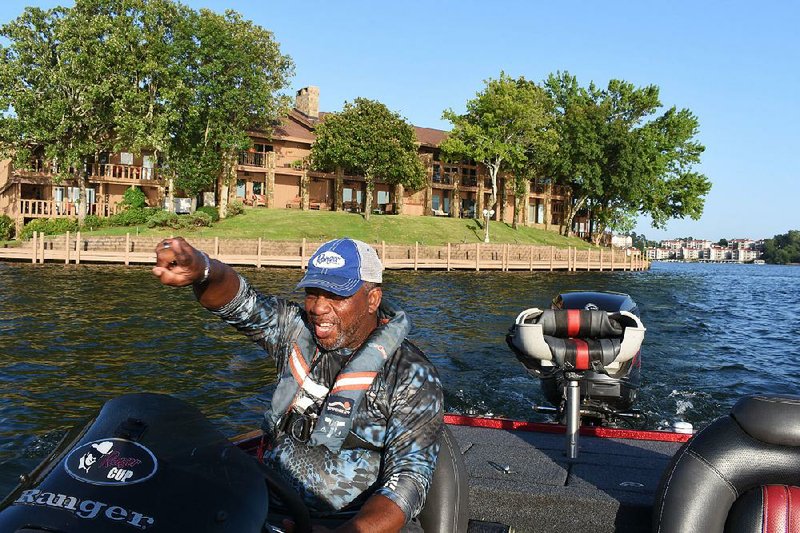 Tyrone Phillips of Little Rock points to a promising fishing spot on the lower end of Lake Hamilton.